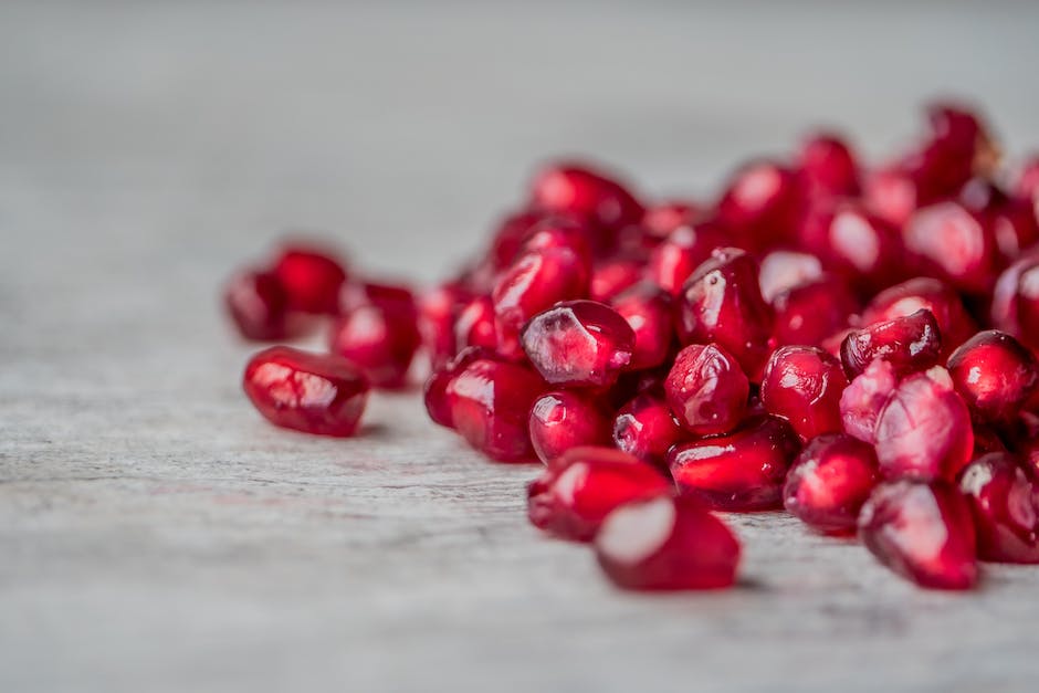 Image of pomegranate seeds ready for planting, showcasing their vibrant red color and unique shape.