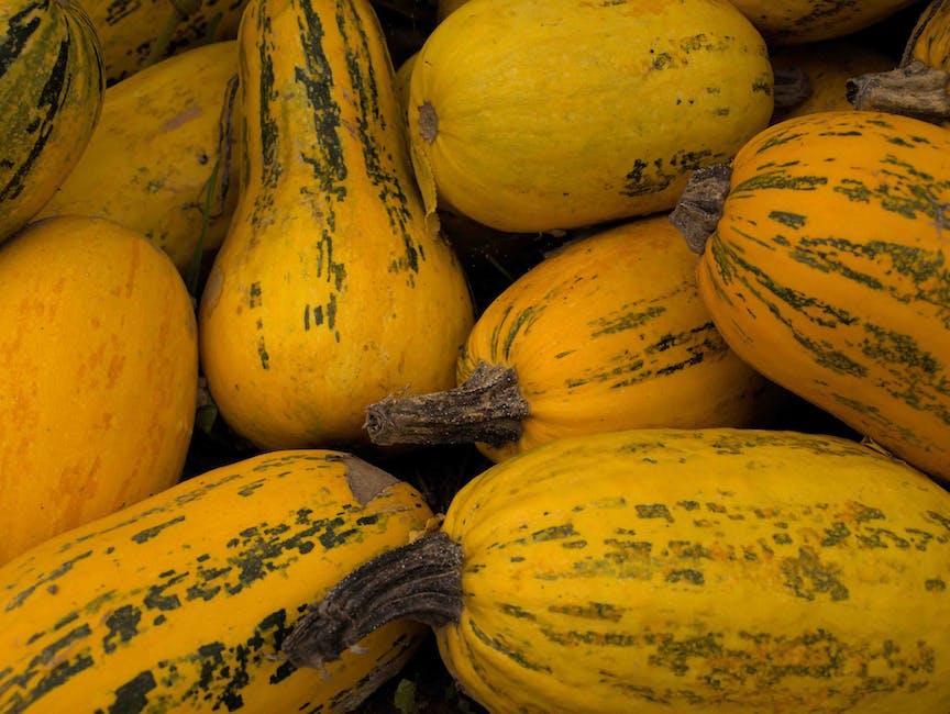 A close-up image of a ripe spaghetti squash with vibrant yellow color, showcasing its unique texture and pasta-like strands.
